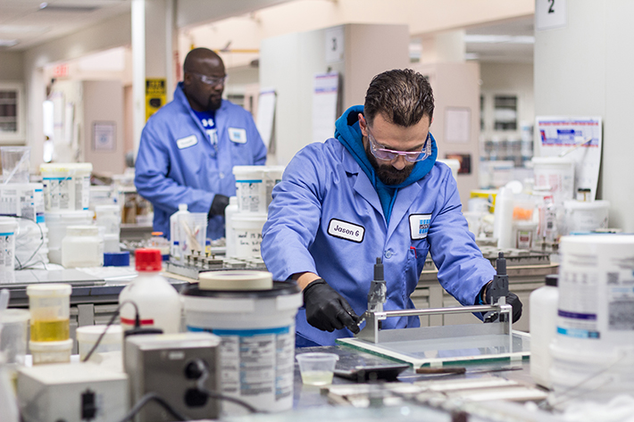 Lab technicians working on tile adhesives