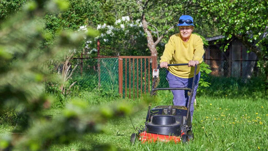 This is a picture of a woman in the green industry working on a lawn maintenance project.